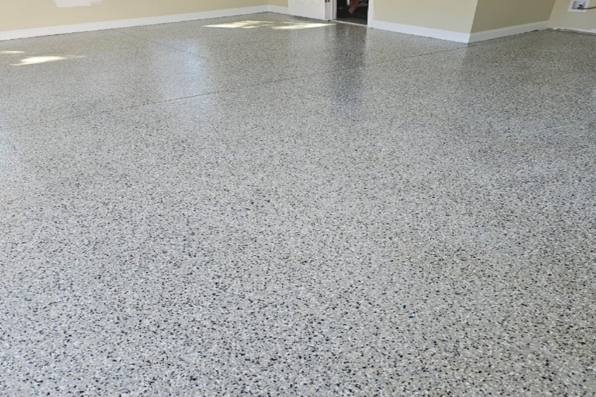 Two-car garage floor after epoxy installation with a clean reflective finish